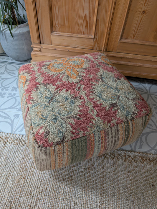 Pouf tuffed wool with filler. Red orange with stribes in the side.